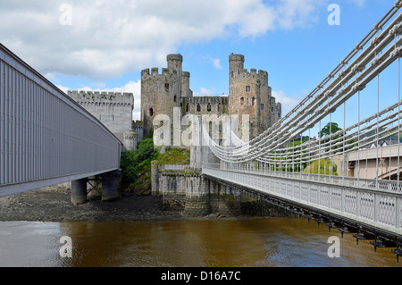 Robert Stephenson tubular railway bridge and Thomas Telford suspension bridge crossing River Conwy Stock Photo