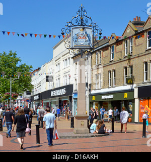 Summer blue sky day for shoppers in Chelmsford City shopping high street & county town coat of arms sign McDonalds & Debenhams stores Essex England UK Stock Photo