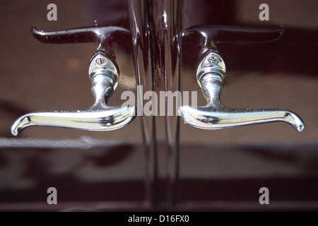 Chrome door handles on the side of a vintage car. Stock Photo