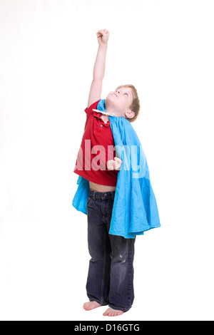 A boy with a cape pretending to fly Stock Photo
