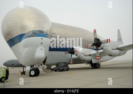 The National Aeronautics and Space Administration’s massive tadpole-shaped aircraft is aptly named “Supper Guppy” and is not only one-of-a-kind in appearance, but also in the operation of its cargo door. A disconnect system at the fuselage break allows th Stock Photo