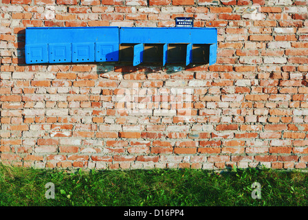 Aged brick construction wall with old post boxes. Stock Photo