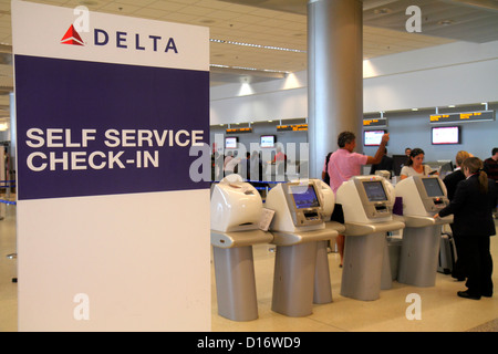 Miami Florida International Airport MIA,terminal,ticket counter,passenger passengers rider riders,Delta Airlines,self service check in,kiosk,FL1210150 Stock Photo