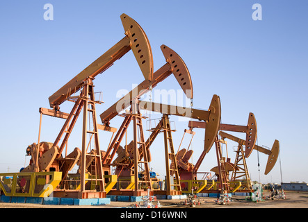 oil pump jacks working at dawn. Stock Photo