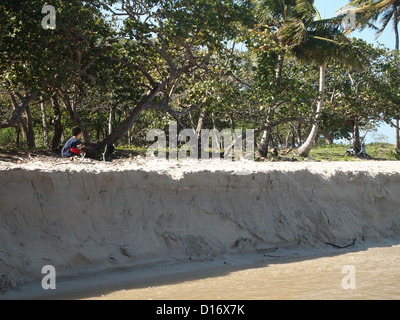 A boy on sandbank at river mouth Stock Photo