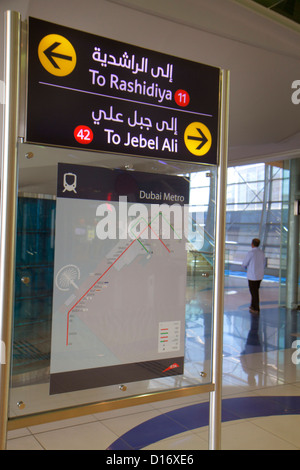 Dubai UAE,United Arab Emirates,Garhoud,Dubai Metro,subway,train,train,Emirates Station,Red Line,sign,arrows,directions,map,English,Arabic,language,bil Stock Photo