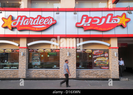 Dubai UAE,United Arab Emirates,Deira,Al Rigga,Al Rigga Road,English,Arabic,language,bilingual,small businesses,district,street scene,Hardee's,fast foo Stock Photo