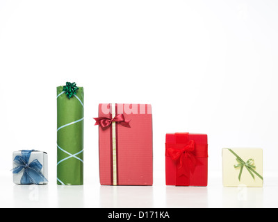 closeup of different colorful gift boxes in a row with beautiful decorations and glittery bows isolated on white background Stock Photo