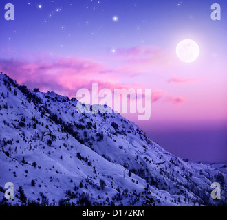 Photo of beautiful snowy mountains on purple sunset background, Faraya mountain in Lebanon covered with white snow, wintertime Stock Photo