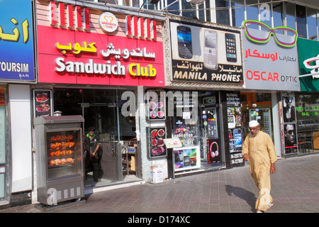 Dubai UAE,United Arab Emirates,Deira,Al Rigga Road,English,Arabic,language,bilingual,Asian man men male adult adults,migrant worker,workers,foreign la Stock Photo