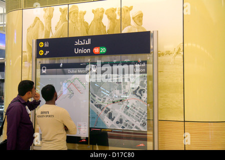 Dubai UAE,United Arab Emirates,Deira,Al Rigga,Union Metro Station,Red Green Line,subway,train,train,Asian man men male adult adults,platform,Bedouin,c Stock Photo