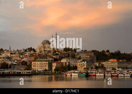 Rustem Pasha and Suleymaniye Mosques with golden sunrise on the waters of the Golden Horn Istanbul Turkey Stock Photo
