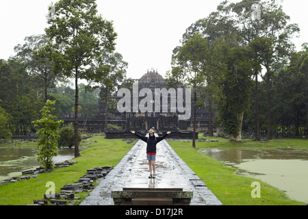 Woman standing on walkway to temple Stock Photo