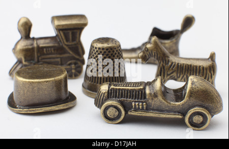 Traditional metal Monopoly playing pieces - Car Dog Train Boot Top Hat and Thimble Stock Photo