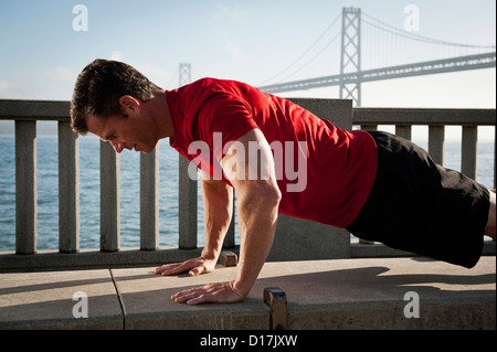 Man exercising on city street Stock Photo