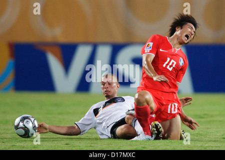 SUEZ, EGYPT - SEPTEMBER 29:  David Vrzogic of Germany (L) tackles Young Cheol Cho of South Korea (R) during the 2009 FIFA U-20 World Cup Group C match at Mubarak Stadium on September 29, 2009 in Suez, Egypt. Editorial use only. Commercial use prohibited. (Photograph by Jonathan Paul Larsen / Diadem Images) Stock Photo