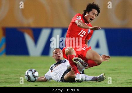 SUEZ, EGYPT - SEPTEMBER 29:  David Vrzogic of Germany (L) tackles Young Cheol Cho of South Korea (R) during the 2009 FIFA U-20 World Cup Group C match at Mubarak Stadium on September 29, 2009 in Suez, Egypt. Editorial use only. Commercial use prohibited. (Photograph by Jonathan Paul Larsen / Diadem Images) Stock Photo