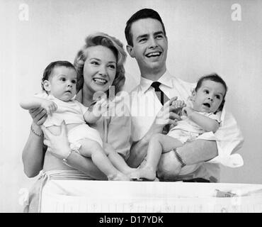 Portrait of happy family with baby twins Stock Photo