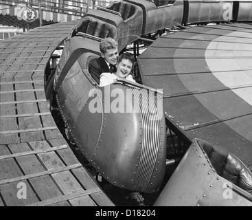 Teenage couple on roller coaster, Coney Island, New York, 1950's Stock Photo