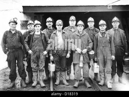 Coal miners at the entrance of a mine Stock Photo