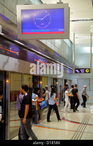 Dubai UAE,United Arab Emirates,Deira,Al Rigga Metro Station,Red Line,subway,train,train,interior inside,platform,riders,Asian man men male,woman femal Stock Photo