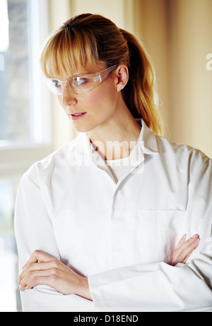 Woman wearing white coat and glasses Stock Photo