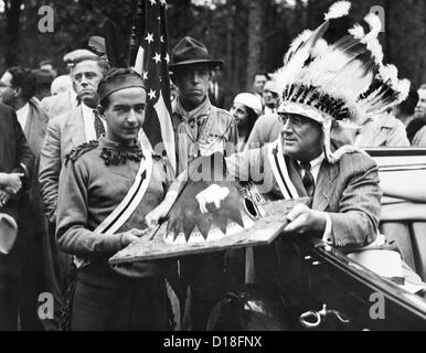 President Franklin Roosevelt in a war bonnet. FDR wears Indian headdress as he receives a miniature Native American teepee from Stock Photo