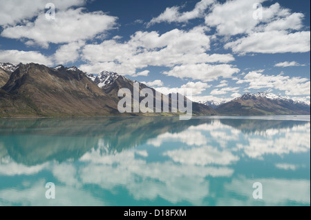 Clouds and sky reflected in still lake Stock Photo