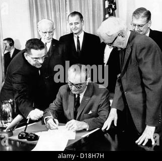 President Lyndon B. Johnson signs the Voting Rights Act of 1965 while ...