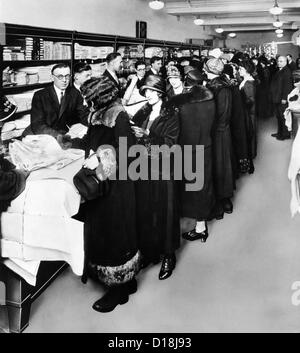 Women eagerly shop across the counter at a newly opened Sears retail store. The First Sears Retail stores opened in 1925 in Stock Photo