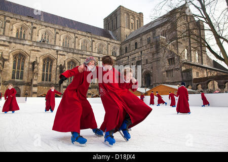 Winchester Cathedral, Hampshire, England, UK.11.12.2012 Picture shows Boy Choristers of Winchester Cathedral skating on the cathedral's ice rink, as part of the annual celebrations running up to Christmas. Stock Photo