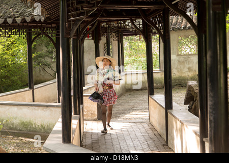 A young Chinese woman in the Humble Administrator's garden in Suzhou, China. Stock Photo