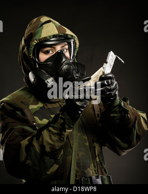 US Marine in MOPP gear inc gas mask uses M272 Chemical Agent Water Testing Kit ( lewisite, nerve agents, cyanide and mustard ) Stock Photo