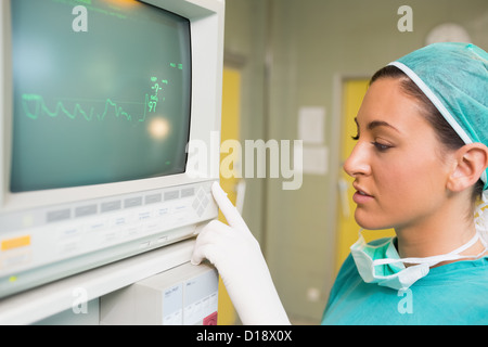 Smiling female surgeon standing next to a monitor Stock Photo