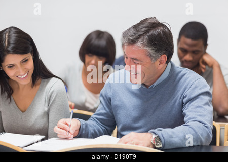 Man and woman talking during lecture Stock Photo