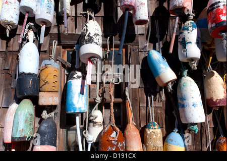 Lobster buoys hanging on the shingle wall of a shed. Stock Photo