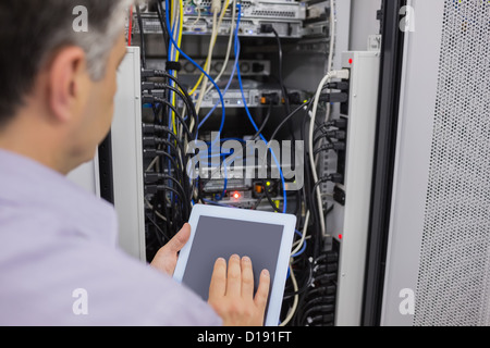 Man doing  server maintenance with tablet pc Stock Photo