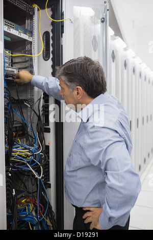 Technician working on a case of server racks Stock Photo