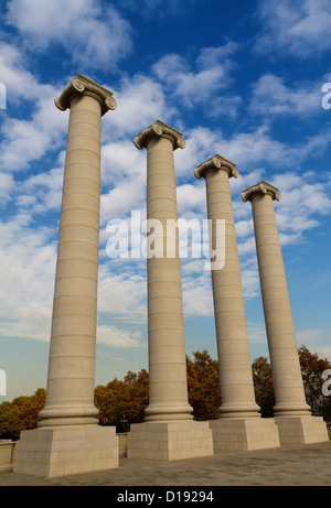 Four massive columns, blue sky Stock Photo