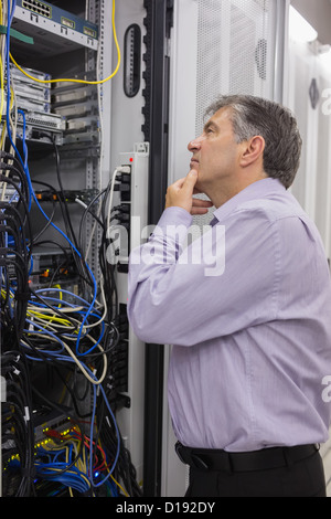 Technician searching for a solution in the server case Stock Photo