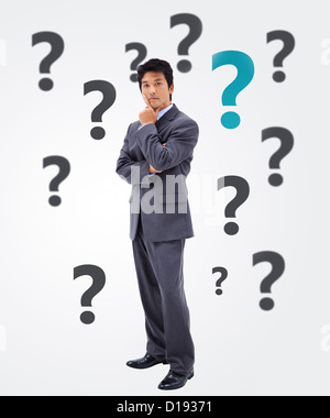 Businessman thinking on question mark background Stock Photo