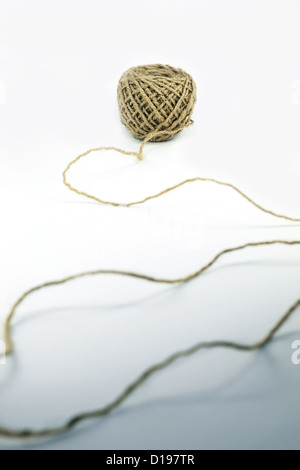Hank of twine with string coming out of it Stock Photo