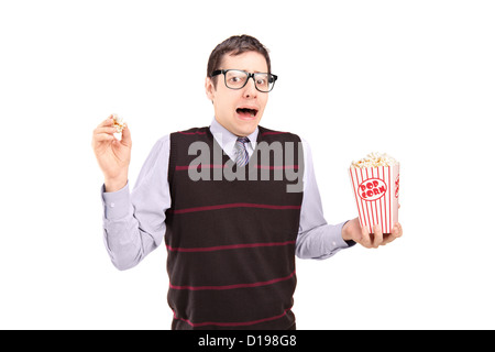 Afraid man holding a popcorn box isolated on white background Stock Photo