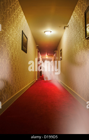 Ghost walking in hotel hallway Stock Photo