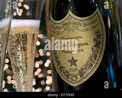 Freshly poured glasses of 2002  vintage Dom Perignon luxury champagne with sparkling lights in background Stock Photo