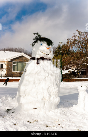 Smiling snowman on an urban street on a sunny afternoon Stock Photo