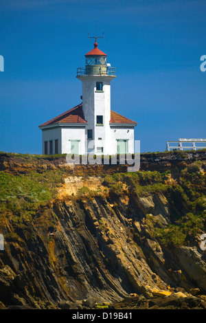 OR00675-00...OREGON - Rocky shoreline and Cape Arago Lighthouse on the Pacific Coast near Sunset Bay State Park. Stock Photo