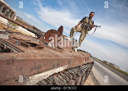 Azaz, Syria, 5/10/12. FSA soldier poses on top a disabled tank outside the town of Azaz,near the Turkish border post of Kellis. Stock Photo