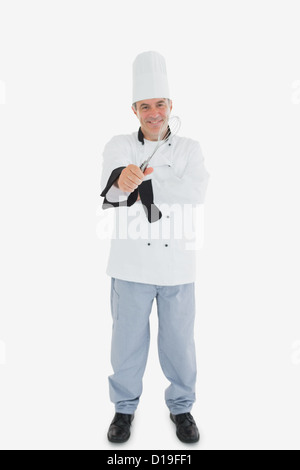 Happy chef holding wire whisk Stock Photo