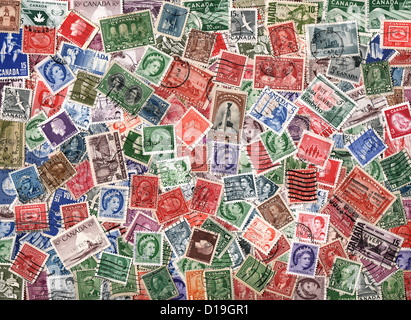 Background of old used miscellaneous Canadian postage stamps Stock Photo